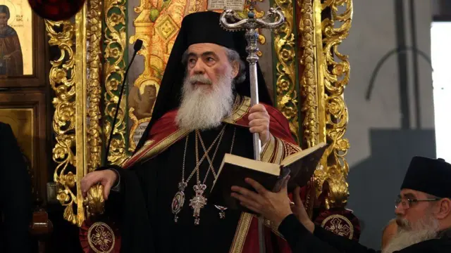 Greek Orthodox Patriarch of Jerusalem Theophilos III dressed in robes and hold a staff