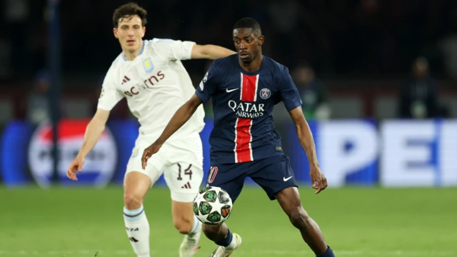 Players aiming for the ball on the pitch