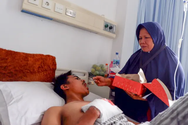 A survivor receiving medical care after being evacuated