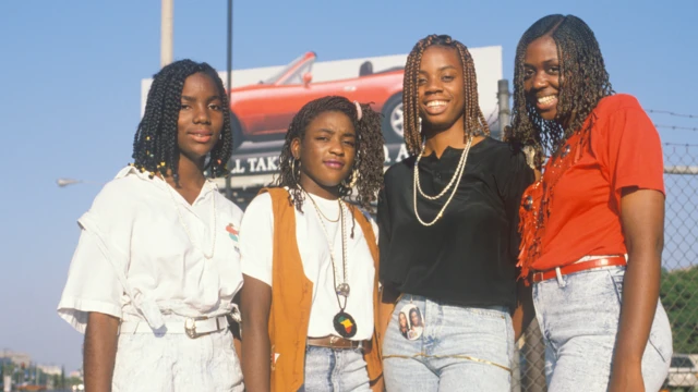 Four African-American women wearing cornrows and braids in a picture 