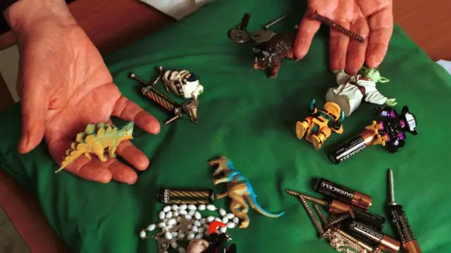 A collection of objects such as toys, batteries and nails