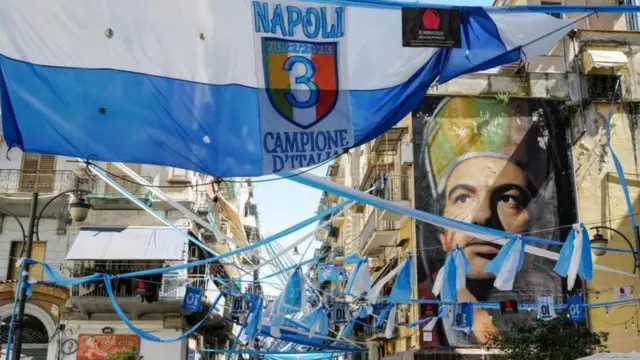 بنرهای جشن قهرمانی ناپولی مقابل نقاشی دیواری سن جنارو در ناپل