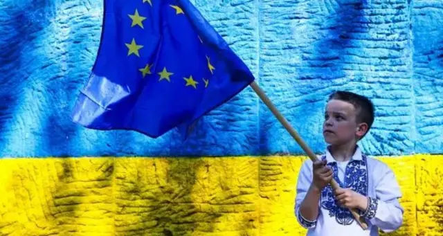 хлопчик з прапором ЄС на фоні прапора України 
