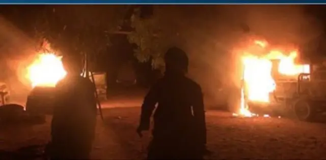 Two people at an explosion site