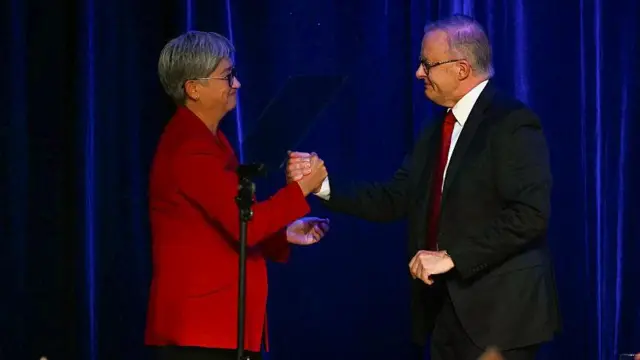Dışişleri Bakanı Penny Wong ve Başbakan Anthony Albanese bir sahnede tokalaşırken