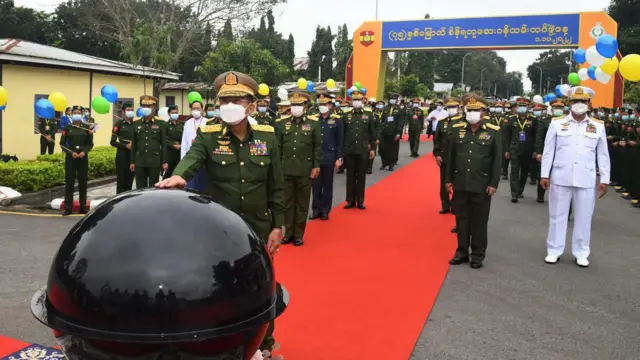 (၇၅)နှစ်မြောက် စိန်ရတုဆေးတပ်ဖွဲ့နေ့ အခမ်းအနားမှာ ပွံတက်ဝတ်စုံအပြည့်နဲ့စစ်ဗိုလ်ချုပ်တွေ၊ အခမ်းအနားကို စက်ခလုတ်နှိပ်ဖွင့်လှစ်ဖို့ ဗိုလ်ချုပ်မှူးကြီးမင်းအောင်လှိုင်က လက်တင်ထားပါတယ်။
