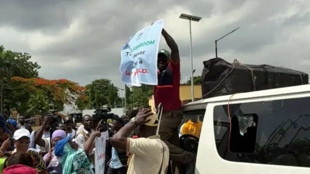 Teachers protest wit placards