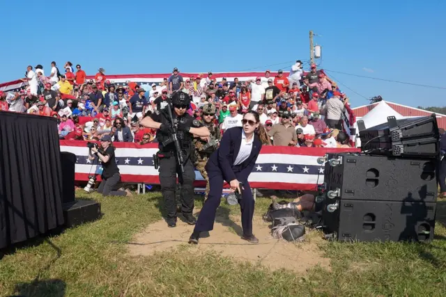 Petugas Dinas Rahasia AS berupaya mengamankan lokasi di sekitar panggung kampanye seusai penembakan.