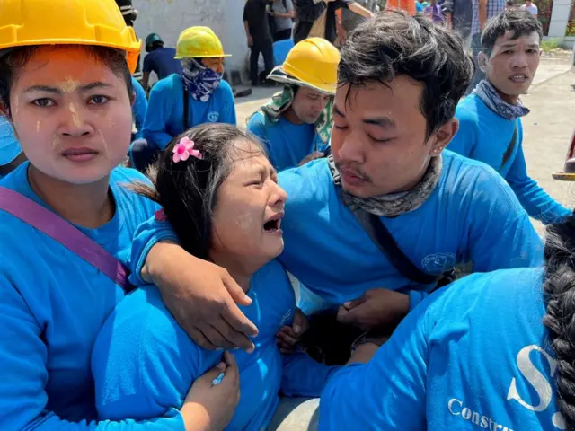 A worker reacts after the tremors of a strong earthquake that struck central Myanmar on Friday affected Bangkok, Thailand, March 28, 2025.