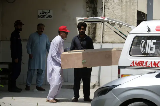 People transport the body of a victim after a fire at the Pakistan Institute of Medical Science (PIMS), in Islamabad, Pakistan, 26 August 2026. According to hospital officials, the fire that broke out in the hospital's maternity ward killed at least 14 newborns.
