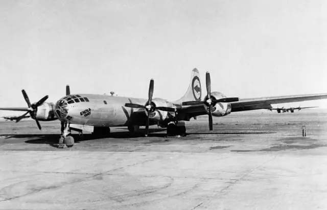 The Enola Gay, the B-29 bomber which dropped the first atomic bomb on Japan, stands on the runway at Tinian following the raid. August 1945