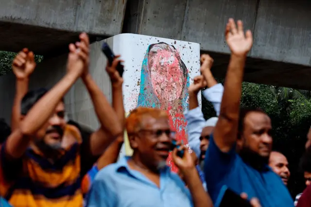 A mural of Prime Minister Sheikh Hasina is seen vandalised by protesters as people celebrate her resignation in Dhaka, Bangladesh, August 5, 2024.