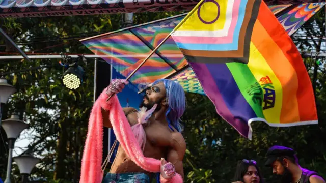 कोलकाता की एलजीबीटीक्यू+ कम्युनिटी के एक सदस्य ने रैली के दौरान प्रोग्रेस प्राइड फ्लैग थाम रखा है. यह रैली प्राइड का जश्न मनाने और एलजीबीटीक्यू अधिकारों की समानता की मांग के लिए आयोजित की गई थी