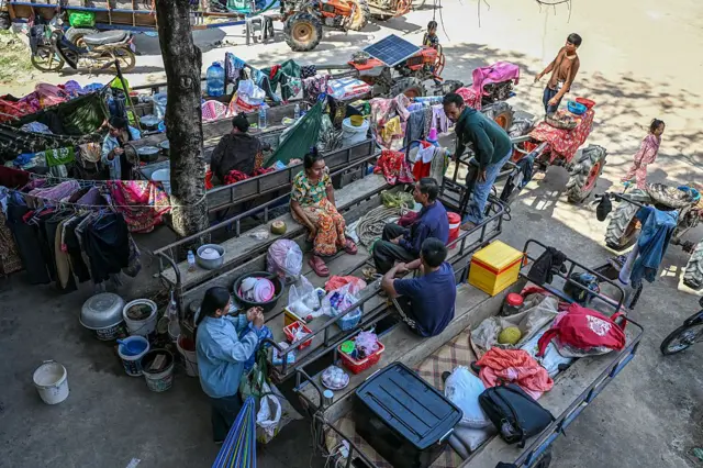 Residents gather outside a temple after they evacuated following clashes along the Cambodia-Thailand border, in Siem Reap province on December 9, 2025. Two more Thai soldiers were killed on December 9, in renewed border clashes with neighbour Cambodia, the Thai army said, raising the death toll for Thai troops to three. (Photo by TANG CHHIN SOTHY / AFP via Getty Images)