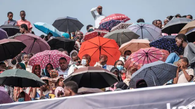 A crowd wait in a stadium in Jimma on June 16, 2021 for an electoral campaign rally of Ethiopian Prime Minister Abiy Ahmed ahead of the June 21, 2021 vote.
