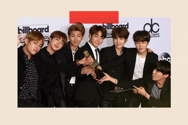 BTS pose with an award