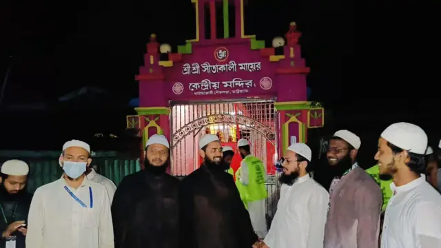 Mainul (third from left) guarding the temple