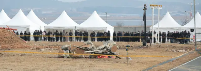 유가족들이 지난달 18일 전남 무안국제공항에서 열린 합동 추모식을 마친 뒤 사고 현장을 찾아 희생자들을 애도하고 있다.