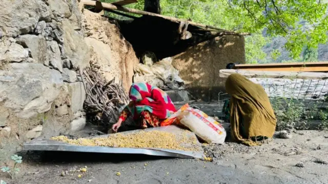 یوې څنډې ته دوه مېرمنې ناستې دي