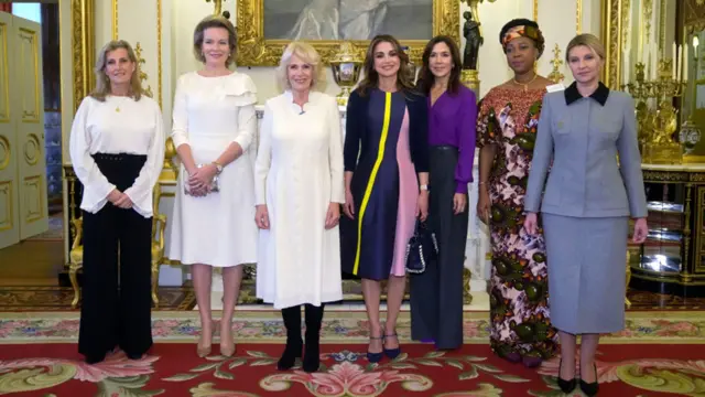 Todoba haween ah ayaa isu taagay sawir kooxeed oo lagu qaaday qol qurux badan oo ay ku xardhan yihiin farshaxanno ku dheggan qaab dahab ah. Haweenkaasi waa: Sophie, Duchess of Edinburgh ee Britain, Boqorad Mathilde ee Belgium, Boqorad Camilla ee Britain, Boqorad Rania ee Jordan, Dhaxal-sugaha boqortooyada Denmark Mary, Fatima Bio, iyo Marwada Koowaad ee Ukraine Olena Zelenska.