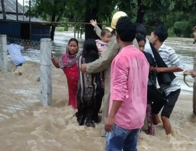 জলে আটকে পড়া ব্যক্তিদের উদ্ধার করা হচ্ছে। 