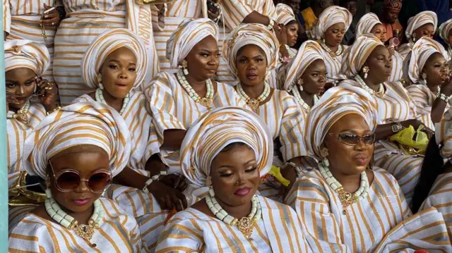 Women dressed in beautiful attires with beads