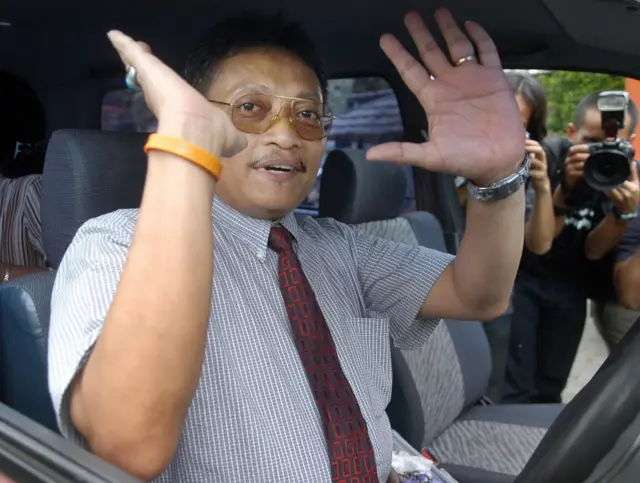 Salah seorang terpidana kasus Munir, Pollycarpus Budihari Priyanto melambaikan tangan sebelum menjalani persidangan.