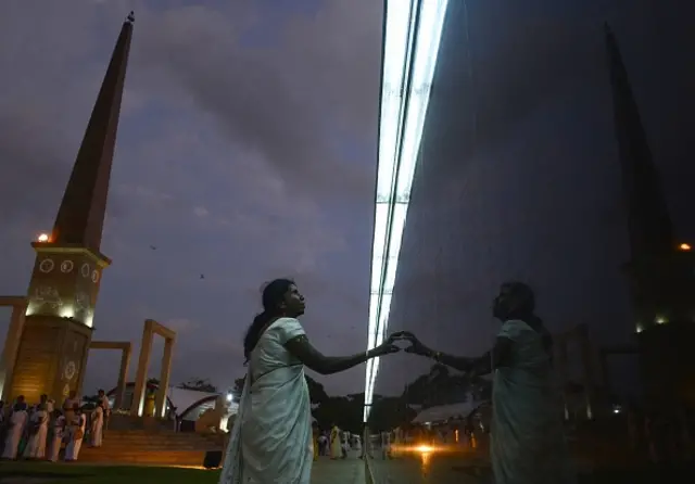 A Sri Lankan woman reads names on a memorial for fallen soldiers during the National War Heroes Day in Colombo on May 19, 2019. - Sri Lanka's president marked the 10th anniversary of the end of a protracted war with Tamil rebels on May 19 by vowing to crush Islamist militants responsible for Easter bombings that killed 258 people. (Photo by LAKRUWAN WANNIARACHCHI / AFP) (Photo by LAKRUWAN WANNIARACHCHI/AFP via Getty Images)