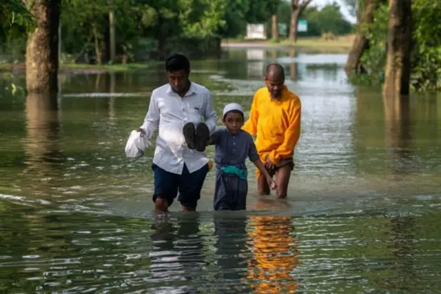 Sylhet's flood-hit people are wading through knee-deep water