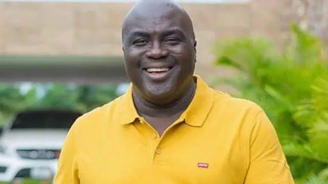 Julius Debrah on yellow shirt wit a smile