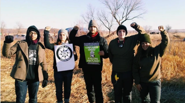 Eygi (soldan ikinci) 2016-17 yıllarında, ABD'nin Kuzey Dakota Eyaleti'nde, Sioux yerlilerinin koruma altındaki alanında, su kaynakları için kirlenme riski teşkil eden petrol boru hattı projesine karşı yürütülen protestolara da katılmıştı. 