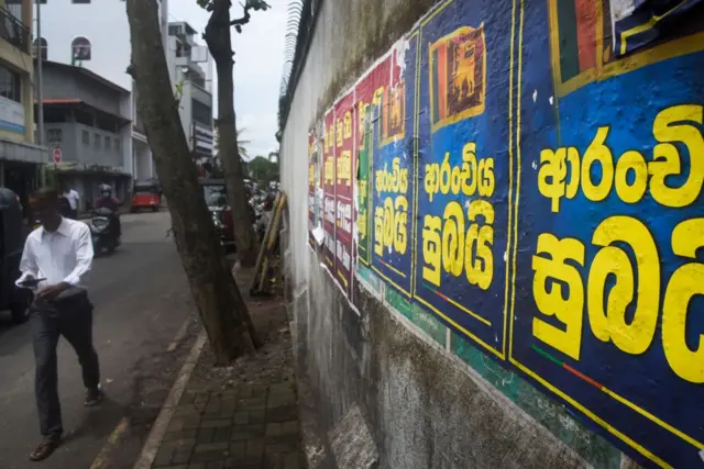 A Sri Lankan is walking past a poster on the roadside with ''Good News'' in Sinhala Language in Colombo, Sri Lanka, on July 16, 2024.