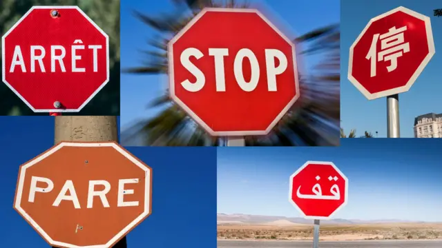 Señales de PARE en varios idiomas, todos iguales: un octágono rojo con letras y bordes en blanco