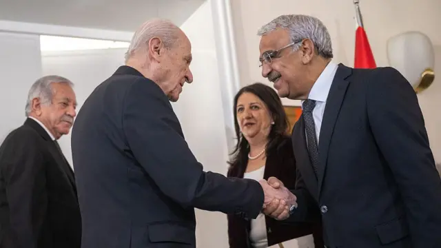 Milliyetçi Hareket Partisi (MHP) Genel Başkanı Devlet Bahçeli (soldan 2.), 12 Aralık 2025 tarihinde Ankara'daki Parlamento binasındaki ofisinde, Türkiye Büyük Millet Meclisi Başkan Yardımcısı Celal Adan (solda) ve Van Milletvekili Pervin Buldan'ın (sağdan 2.) da aralarında bulunduğu Demokrasi ve İlerleme Partisi (DEM) heyetini kabul ederken.