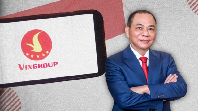 Ảnh thiết kế: ông Phạm Nhật vượng mặc vest xanh, sơ mi trắng thắt cà vạt đỏ bên nền logo Vingroup