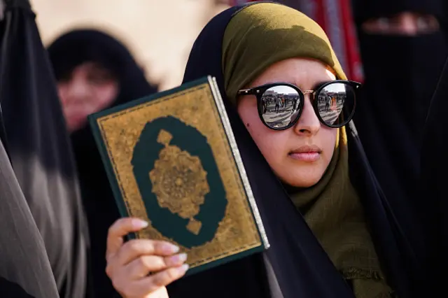 Supporter of Iraqi Shi'ite cleric Moqtada al-Sadr, holds a Koran during the demonstration in the city of Mosul, to condemn the burning of the Koran in Sweden. An Iraqi citizen living in Sweden, stomped on the Koran and set several pages alight in front of Stockholm's largest mosque in Sweden on the first day of Eid al-Adha. (