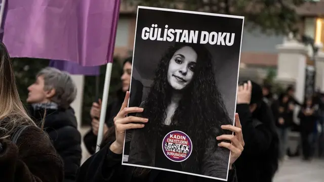 15 Nisan 2026'da Gülistan Doku için İstanbul'da düzenlenen bir eylemde bir kadın, üzerinde Doku'nun resminin olduğu bir döviz taşıyor. 