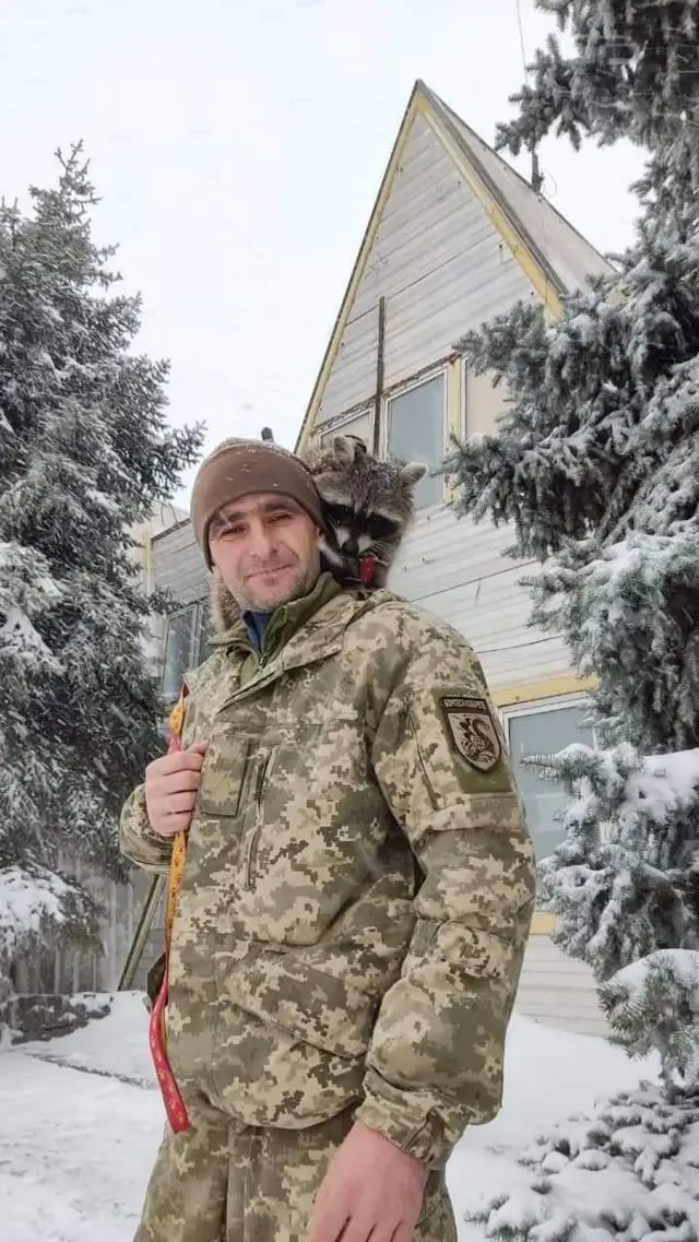 Олександр Савов у зимовому військовому камуфляжі в кадрі дод пояса з маленькою тваринкою на плечі, схожою на бобра