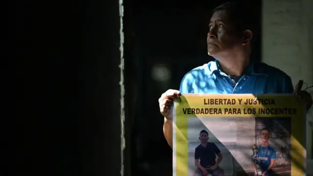 Reynaldo Santos Vanegas mostra um cartaz com fotos do seu filho Jonathan Santos Castillo, preso durante o estado de emergência decretado pelo governo salvadorenho para combater um grupo criminoso, durante entrevista em Soyapango, no dia 25 de outubro de 2024