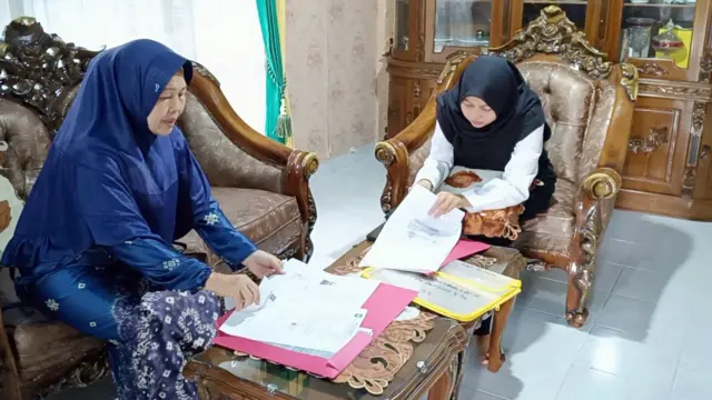 Inayah (kanan) dan Marliah menunjukan dokumen kewarganegaraan.