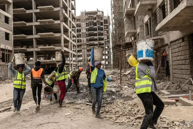 Pekerja konstruksi membawa material bangunan di Soweto-B di Kibera, Nairobi, pada 5 Agustus 2025.