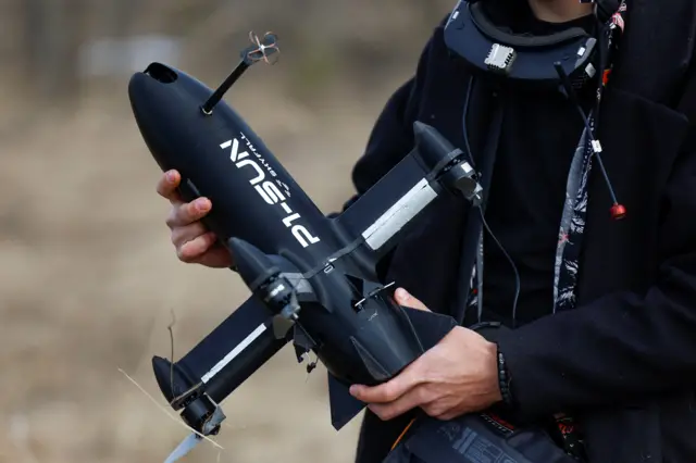 Чоловік тримає в руках дрон перехоплювач