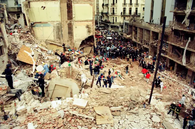 Rescatistas trabajan entre los escombros de una edificación caída