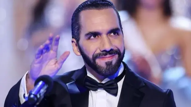 Nayib Bukele acena com a mão vestido em traje de gala