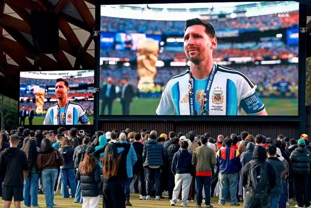 Taraftarlar, 20 Temmuz 2026'da Sidney'de, İspanya'nın 2026 Dünya Kupası futbol finalinde Arjantin'i mağlup etmesinin ardından Arjantinli Lionel Messi'nin tepkisini dev ekranlardan izliyor.
