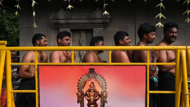 चेन्नई के एक मंदिर में 17 नवंबर 2021 को श्रद्धालु भगवान अय्यप्पा की पूजा के लिए लाइन में खड़े पुरुष श्रद्धालु.