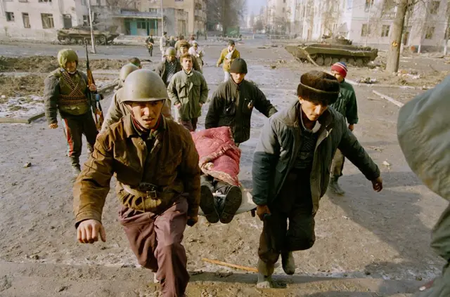 Защитники Грозного выносят раненого 