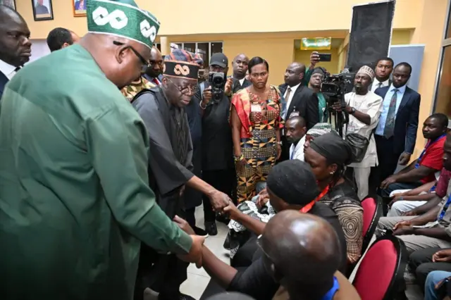 President Tinubu as e dey console victims of di attack.