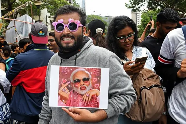 A demonstrator is seen holding a placard of Indian Prime Minister Narendra Modi during a protest in Mumbai. Youths supporting Cockroach Janata Party (CJP) held a protest against alleged paper leaks and irregularities in major national medical entrance examinations, seeking resignation of Union Education Minister Dharmendra Pradhan, demanding greater accountability and reforms in India's education system. 