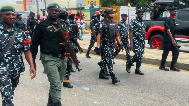 Nigeria police wit guns marching on di streets